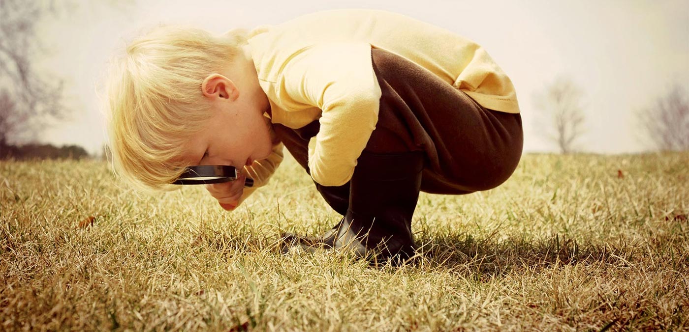 boy exploring child grass carousel