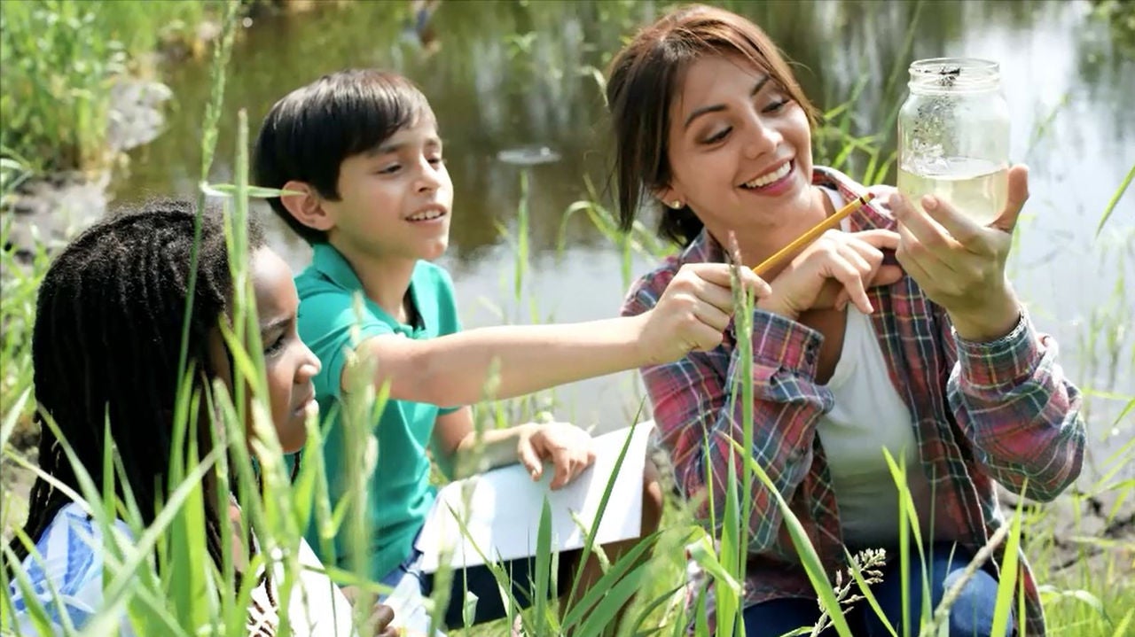 teacher with kids outside